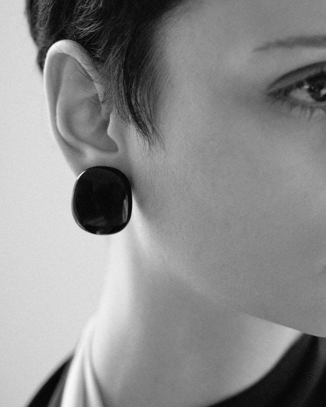 Camille Surault's BLOWBLOW earrings small in black resin, front view. 