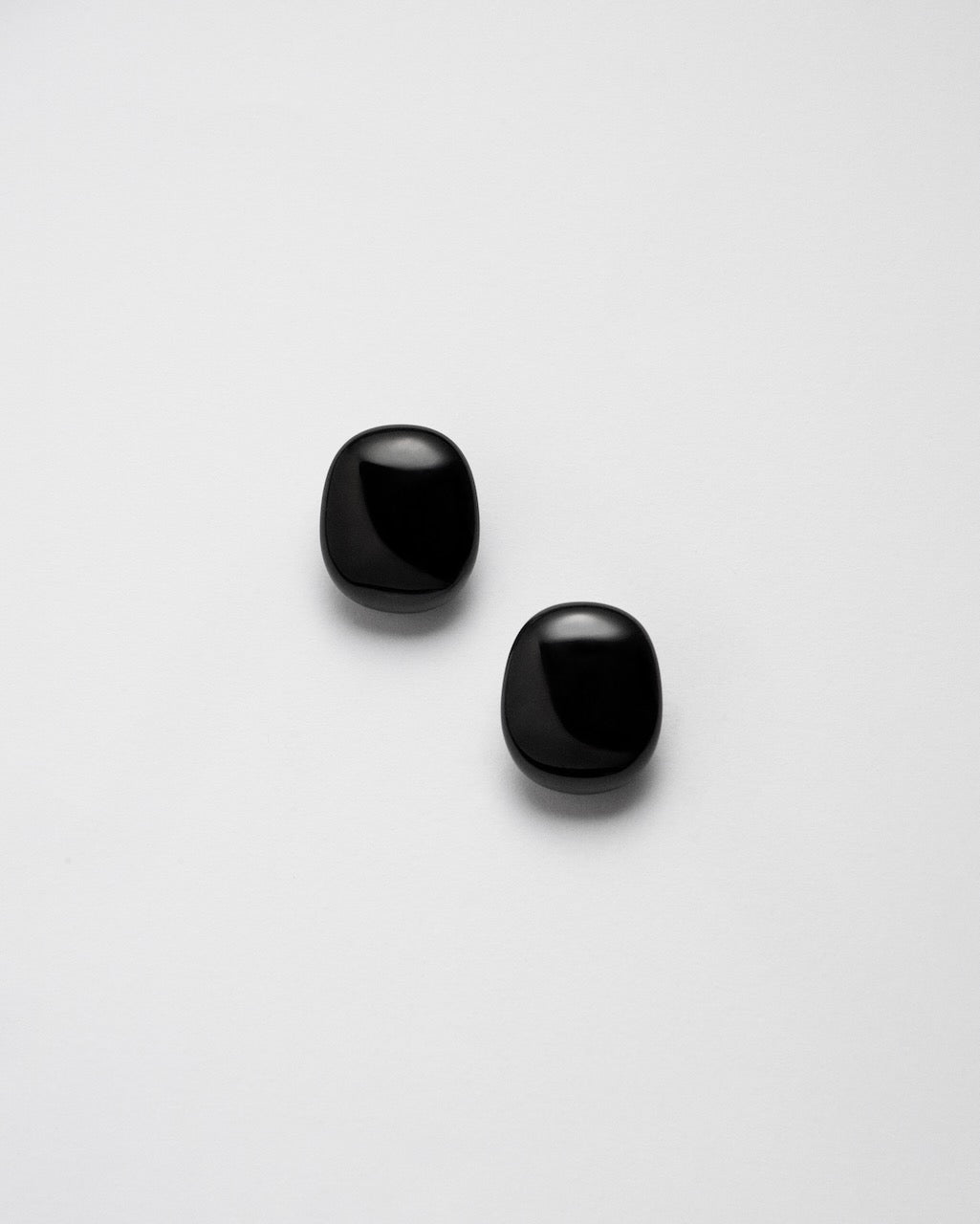 Camille Surault's BLOWBLOW earrings small in black resin, front view. 